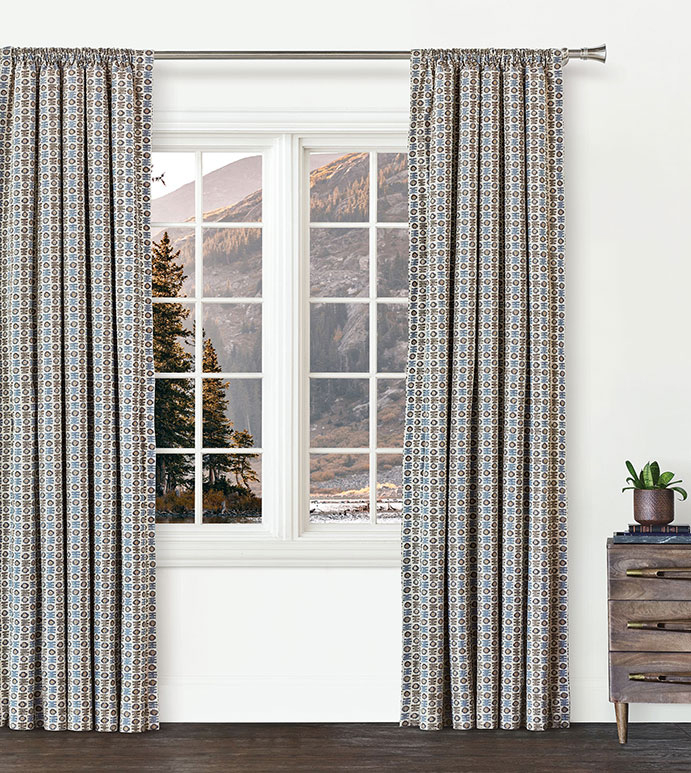 Kane Geometric Drapery, Eastern Accents: Intricately patterned Bozeman draperies in blue and brown tones create a playful, curated look while framing a stunning mountain view.