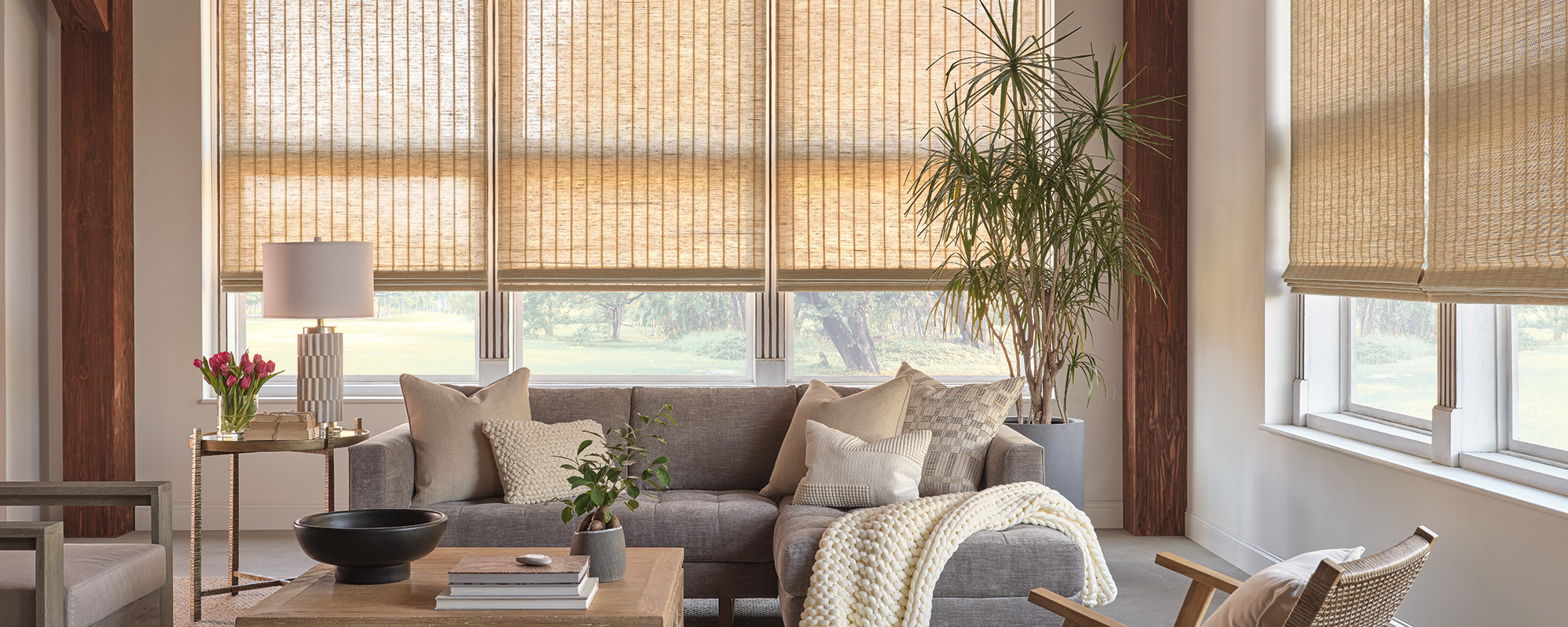 Provenance woven wood shades softening daylight in a bright sitting area with modern and traditional decor elements—natural texture window shades in Bozeman.