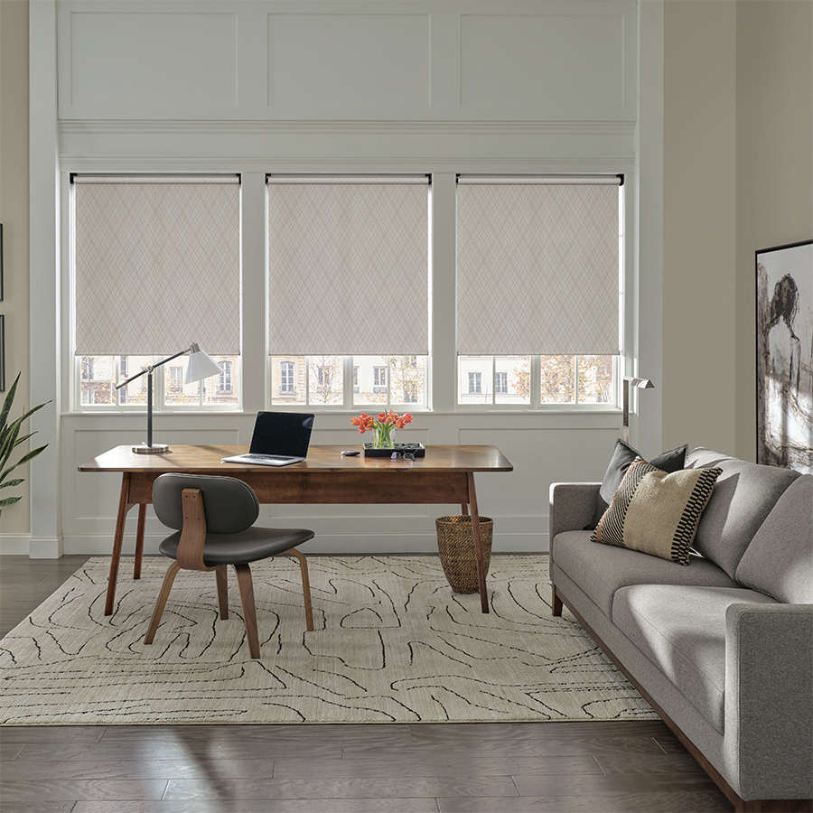 Sleek white roller shades in a contemporary home office, offering light control and style with window shades in Bozeman.