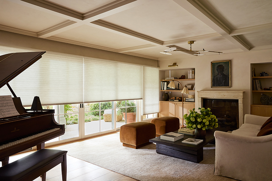 Cellular honeycomb shades softly diffusing light in a large great room with sliding patio doors, showcasing energy-smart window shades in Bozeman.