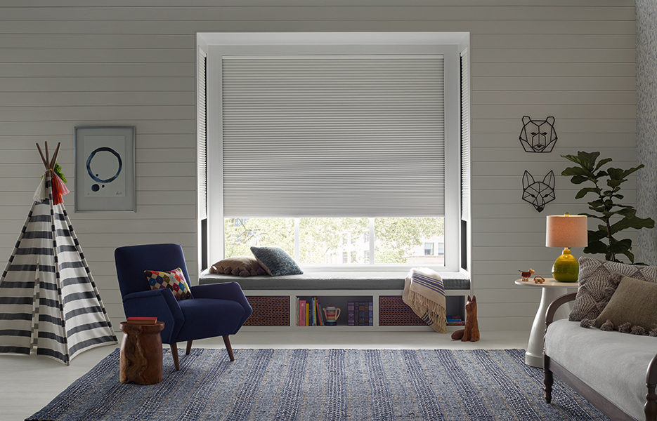 Room-darkening Duette LightLock shades installed in a cozy kids' bedroom with layered textures and warm tones, part of the custom shades Bozeman selection.