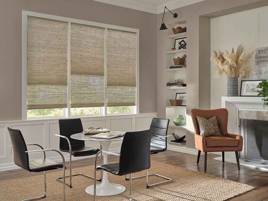 Provenance woven wood shades filtering light in a modern Bozeman lounge area, highlighting the warmth and texture of organic shades.