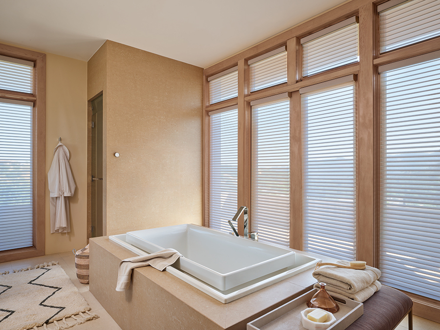 Silhouette window shadings in a spa-like Bozeman bathroom, allowing personalized privacy and light flexibility.