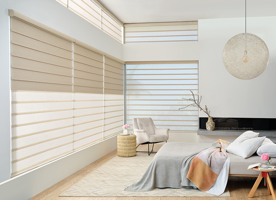 Vignette modern roman shades in a Bozeman bedroom, blending blackout and sheer functionality for day-to-night window shade versatility.