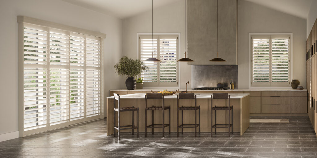 Custom-fit NewStyle® Hybrid shutters in a Bozeman kitchen dining nook provide practical privacy, seamless light control, and a crisp modern look in natural tones.