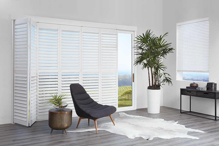 Neutral-toned Bozeman shutters in a spacious lounge deliver flexible light filtering and classic appeal, perfect for relaxed Montana interiors.