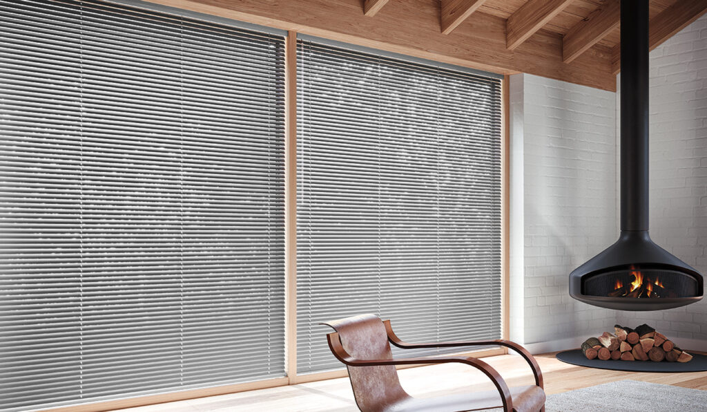 Sleek precious metal blinds in silver bring a modern edge to this Bozeman home office, offering durable functionality with industrial flair.