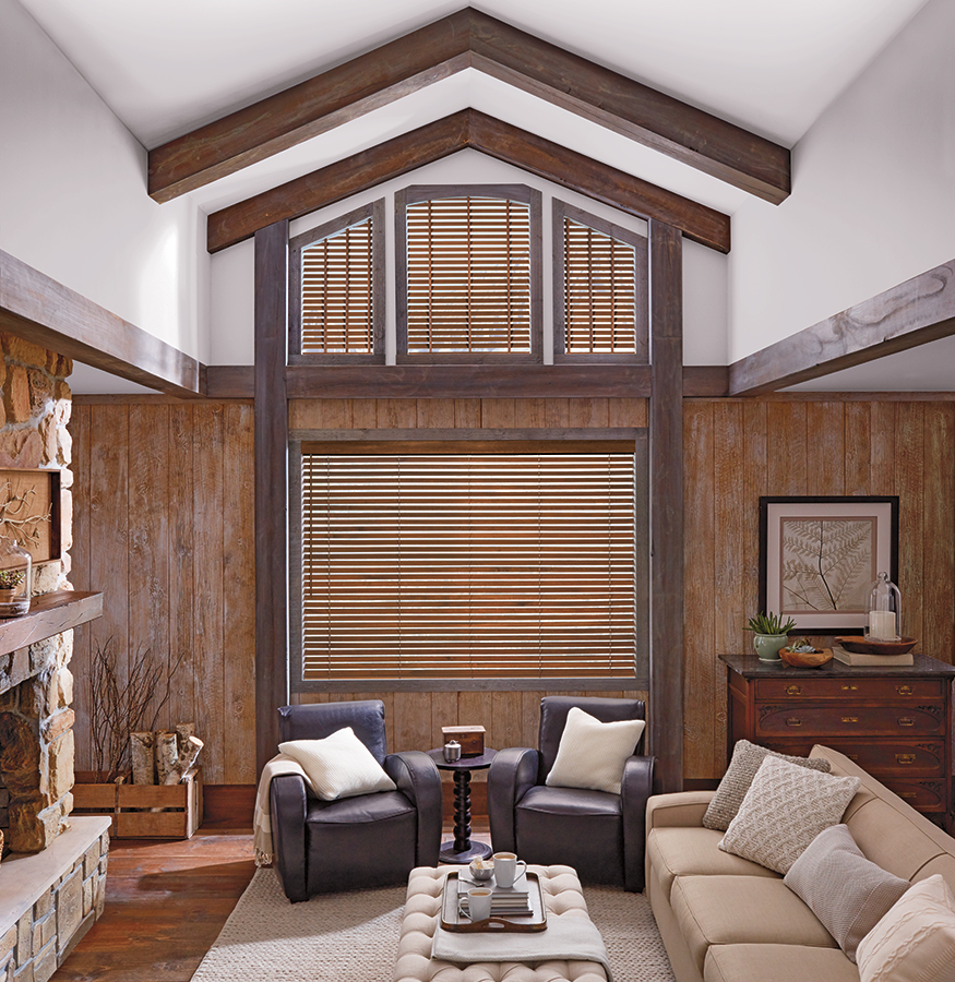Rich wood Bozeman blinds from the Parkland collection add warmth and architectural interest to this vaulted ceiling living room.